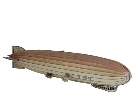 A 1930'S GERMAN TINPLATE CLOCKWORK AIRSHIP possibly Tippco, with opening forward gondola, stencilled 'R 100', 65cm long. Prov