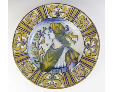 An Italian majolica charger, 19th century, decorated in typical colours with a profile portrait against a washed blue ground 