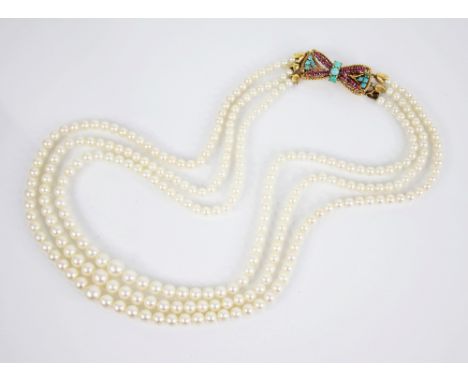 A cultured pearl necklace with 18ct ruby and turquoise set clasp, comprising three rows of round cultured pearls, measuring b