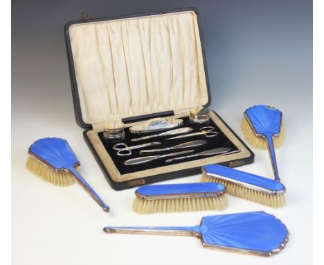 A George V silver mounted vanity set, Daniel Manufacturing Company, Birmingham 1930-31, comprising two cut glass jars, a shoe