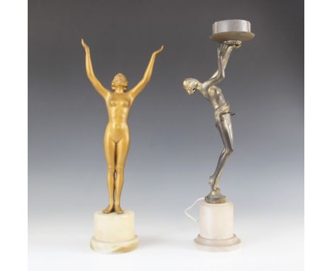 Two Art Deco gilt spelter figural table lamps, each modelled as a young woman with arms raised, upon an alabaster socle plint