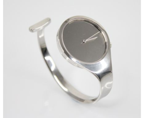 Vivianna Torun for Georg Jensen, a stainless steel bangle watch, the circular mirrored dial with silver hands, plain polished