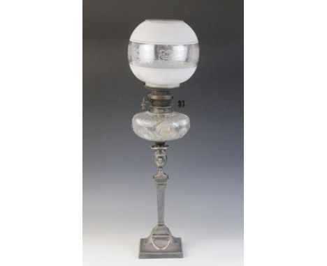 An Edwardian Adams influence silver plated oil lamp, the associated etched glass shade above a cut glass reservoir, and an as