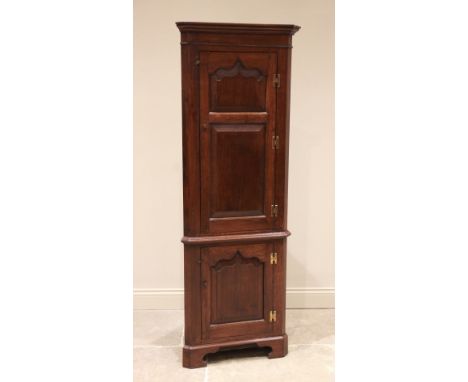 An 18th century style oak freestanding corner cupboard, in the manner of Titchmarsh and Goodwin, late 20th century, the mould