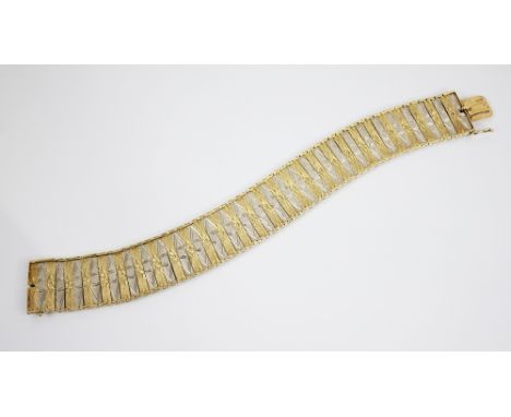 A bi-colour 14ct gold bracelet, comprising alternating rectangular yellow gold and white gold links with engine turned decora