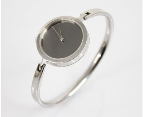 Vivianna Torun for Georg Jensen, a stainless steel bangle watch, the circular mirrored dial with silver hands, plain polished