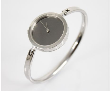 Vivianna Torun for Georg Jensen, a stainless steel bangle watch, the circular mirrored dial with silver hands, plain polished