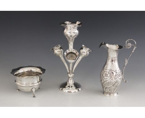 A late Victorian silver ewer, Maurice Freeman, London 1899, of baluster form with shaped border and scrolling handle, embosse