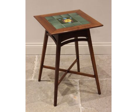 A tiled top mahogany occasional table in the manner of Liberty, the square top centred with an Art Nouveau foliate stylised t