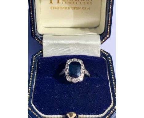 An early 20th century sapphire and diamond cluster ring, the central rectangular cushion mixed cut sapphire measuring 9.4mm L