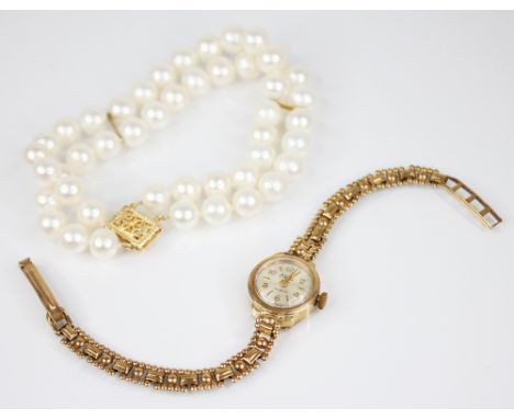A ladies vintage 9ct gold Avia wristwatch the round silvered dial with Arabic and baton markers, set to a plain polished 9ct 