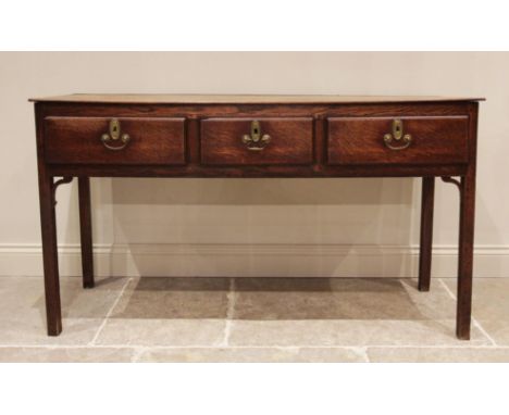 A George III oak dresser, the rectangular top with rounded front corners above three lip moulded frieze drawers, raised upon 