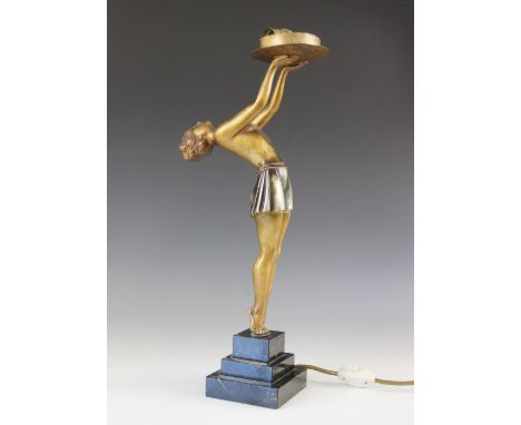 An Art Deco gilt spelter figural table lamp, modelled as a young woman leaning back with arms raised, upon a stepped marble p
