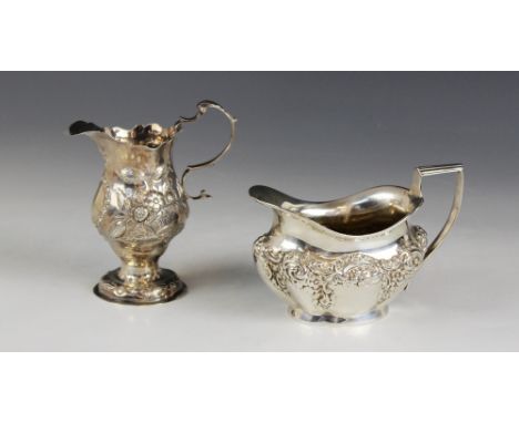 A George III silver cream jug, Charles Hougham, London 1777, of baluster form with shaped rim on pedestal foot, acanthus capp