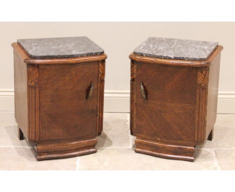 A pair of French style oak marble top bedside cupboards, mid 20th century, each of serpentine form, the single doors opening 