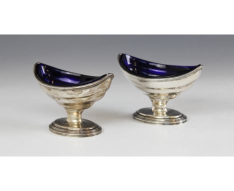 A pair of George III silver salts, marks for 'W.S' London 1785, each of navette form on oval pedestal foot with beaded border