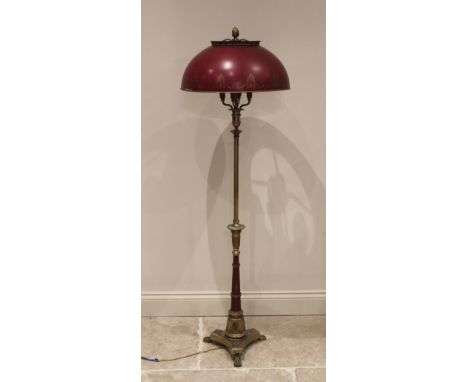 A Regency style brass and toleware standard lamp, early 20th century, the fruit finial above a domed toleware shade and a fou