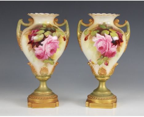 A pair of Royal Worcester blush ivory urns, model number 1959, early 20th century, each of inverted baluster form decorated w