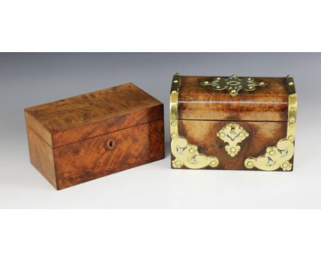 A 19th century figured walnut tea caddy, of domed form applied with polished brass mounts and rivet detail, opening to a pair
