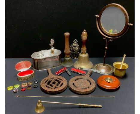 An EPNS caddy, hinged cover; a dressing table mirror, reversible; two hand school bells; a tape measure; two cast iron trivet