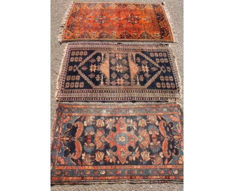 A hand woven geometric carpet, in shades of blue and red with tassels, 92cm wide; another smaller hand woven runner, with geo