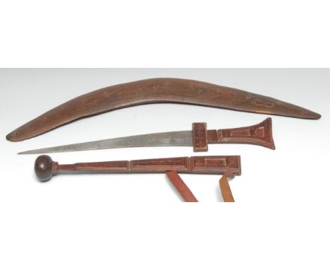 An African dagger, 31cm curved blade, tooled leather hilt and scabbard, 47.5cm long; an Australian Aboriginal boomerang, carv