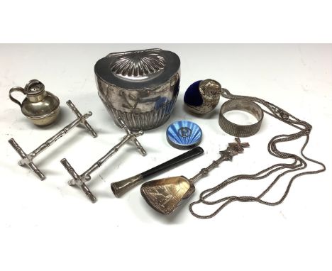 An early 20th century silver plated novelty pin cushion, as a chick; a plated novelty pepper, as a Jersey can; a plated tea c