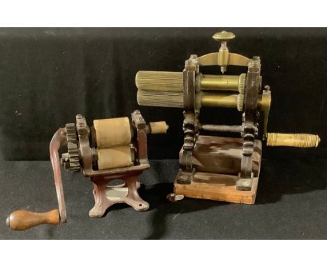 A 19th century brass crimping iron, cast iron stand; another, table top roller (2) 