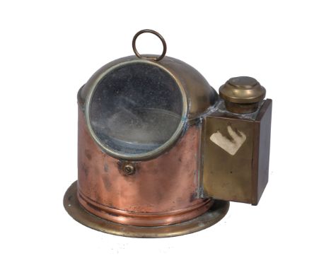  A life boat compass,   in polished brass and copper case with observation glazed panel and burner compartment. Height 25cm. 