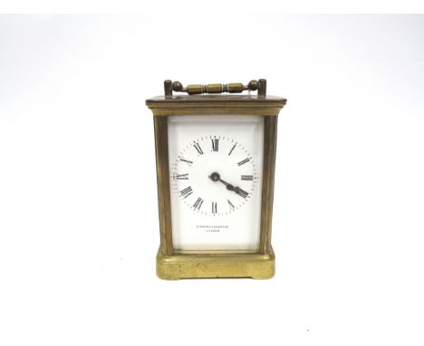 A Jenner &amp; Knewstub of London brass carriage timepiece with bevel edge glass panels, white dial with roman numerals, visi