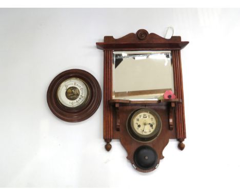A wall hanging bracket mirror with brass cased ship’s style clock and bell, together with a wall dial barometer (2)