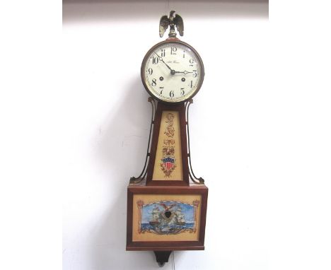 An American Seth Thomas wall clock of banjo style, naval battle scene to glass panel, surmounted by a brass eagle, with signe