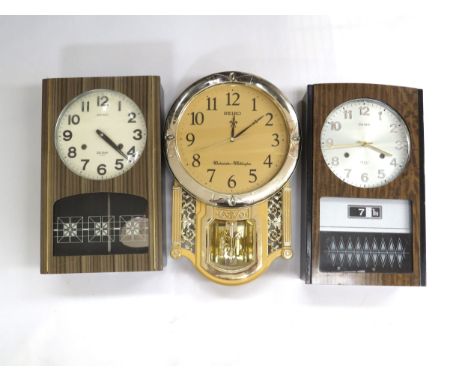A Seiko 30 day wall clock with day/date aperture, a similar Seiko 30 day wall clock and a Seiko Westminster-Whittington gold 