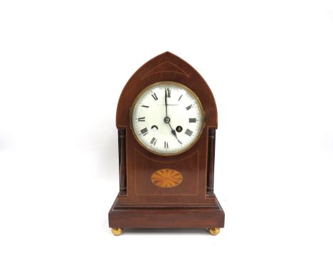An arch cased marquetry inlaid 8-day mantel clock by Sir John Bennett Ltd of London, signed white enamel Roman dial, inlaid c