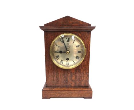 A mid 20th Century WWII oak cased officer's mess mantel clock, circa 1939, silvered Roman dial with RAF insignia, triangular 