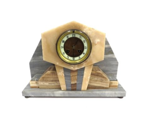 An Art Deco multi stone mantel clock signed "Examined by J. B. Yabsley of 72 Ludgate Hill London", enamel Arabic chapter ring