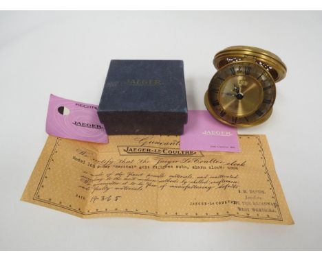 JAEGER-LECOULTRE: A gilt brass Jaeger "Recital" 8-day travelling alarm clock, model number 105, glazed brass dial with 24 hou