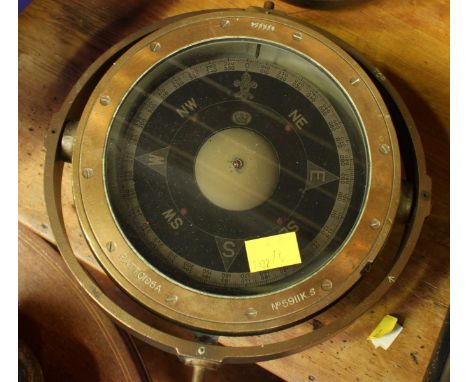 A mid 20th century ships brass wet gimbal compass, number 5911K.S. the compass card with crown logo, in a gimbal frame. 26 cm