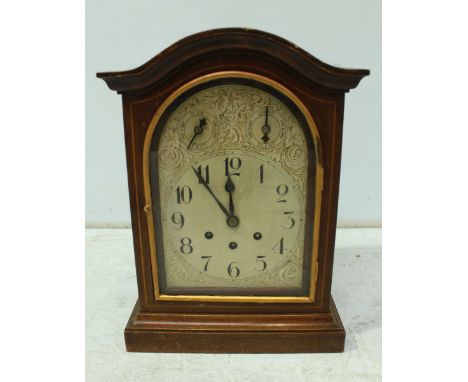 An early 20th century mahogany mantel clock with engraved silvered dial and blacked Arabic numerals, with striking movement. 