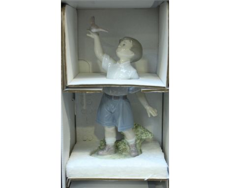 Two boxed Lladro porcelain figures of a boy and a girl with ducks.