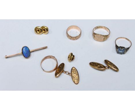 A collection of assorted gold jewellery including four rings, an opal doublet bar brooch, a pair of engraved oval cufflinks a