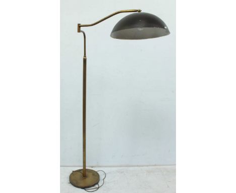 A large early 20th century brass standard lamp, with toleware black painted shade.