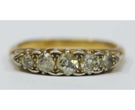 An 18ct gold and diamond five stone ring, set with central stone weighing approx. 0.25cts, flanked by smaller stones. 3.7 gra