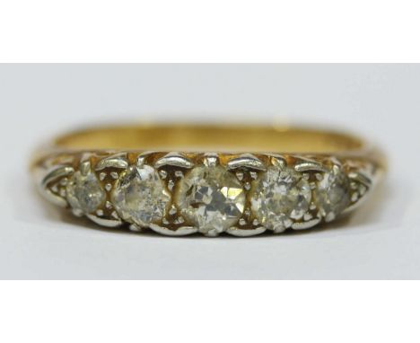 An 18ct gold and diamond five stone ring, set with central stone weighing approx. 0.25cts, flanked by smaller stones. 3.7 gra