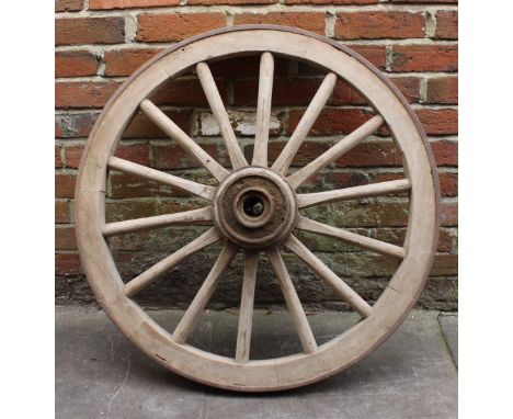 A handmade wooden cartwheel with iron hub and ring, 87cm diam