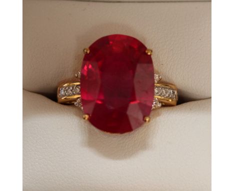 An 18ct gold, ruby and diamond ring, set with large oval ruby weighing approx 15.95cts, the shoulders set with diamonds total