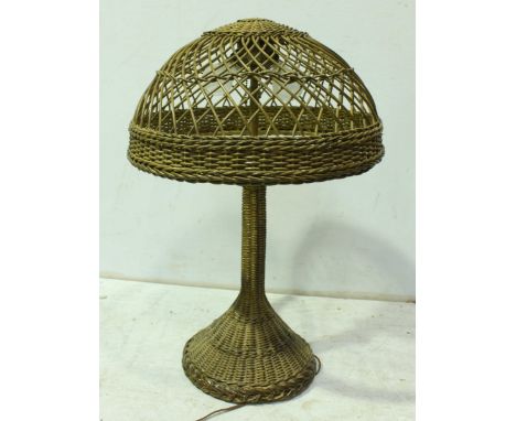 A 1920s painted wicker table lamp, with large domed shade and tapered base. 65 cm high.