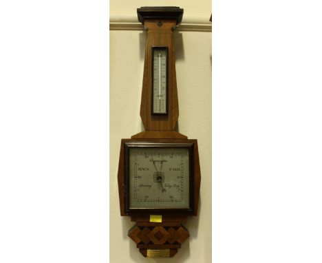 A 20th Century aneroid barometer in geometric stylized mahogany banjo case, with silver dialled thermometer and barometer. 70