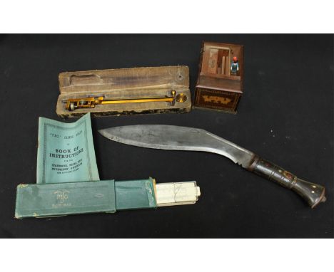 A Stanley brass draughtsman's compass with hinged arm in a fitted case, together with a slide rule, a horn handled kukri knif