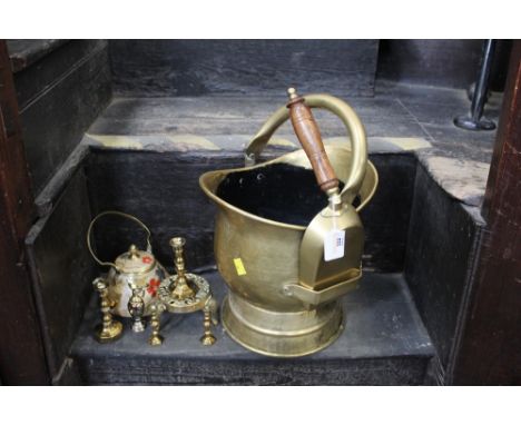 A coal helmet with shovel, brass candlesticks, trivet, decorative teapot etc